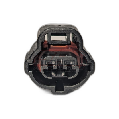 Front view of black 2-pin Toyota IAT air temperature sensor connector housing showing terminal cavities and red seals installed