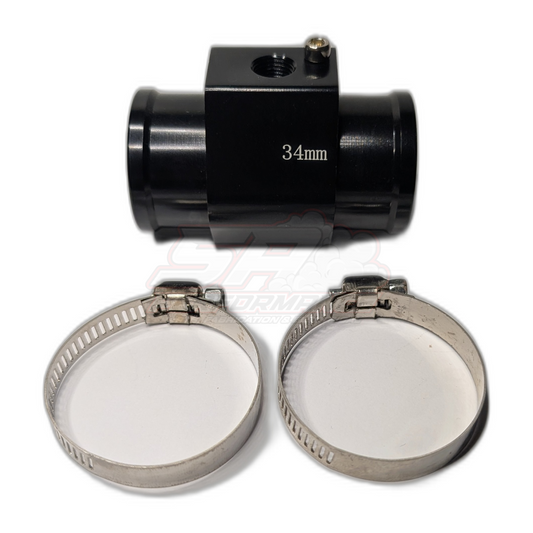 Black anodised aluminium 34mm coolant hose adapter with 1/8 NPT sensor port and silver bleed screw, shown with two stainless steel hose clamps