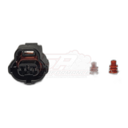 Black 2-pin Toyota IAT sensor connector housing with red seals and terminals separated, showing internal terminal slots and red rubber gasket