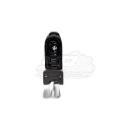 Front view of black Toyota 2-pin Denso ignition coil connector housing open showing internal terminal slots and locking tab, with loose metal terminals below
