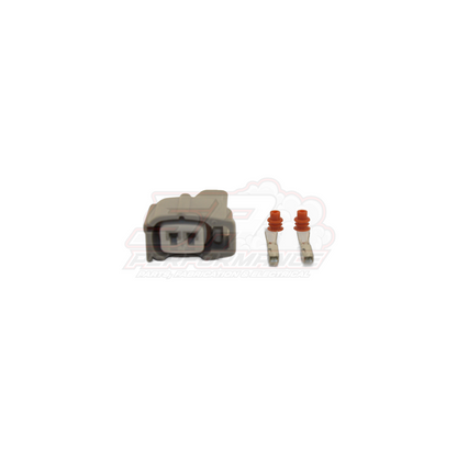 Denso 2-pin injector connector kit showing grey housing with two terminals and orange rubber seals for Nissan Toyota Mitsubishi