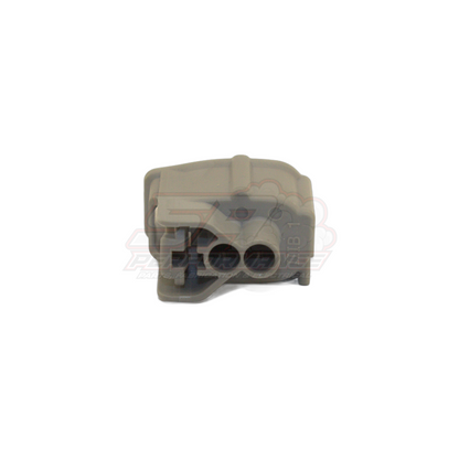 Grey Denso 2-pin injector connector front view showing two circular terminal openings and locking tab for Nissan Toyota Mitsubishi fuel injectors