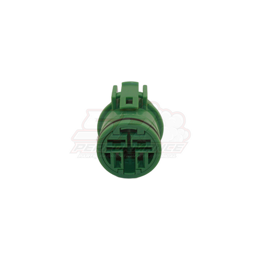 Front view of Denso 4-pin green round connector showing circular terminal layout with locking tabs for late model alternators