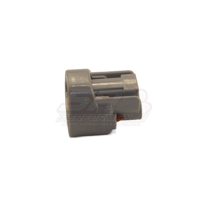 Grey 2-pin Denso left guide connector housing shown from angled front view with visible keyway slots and orange seal