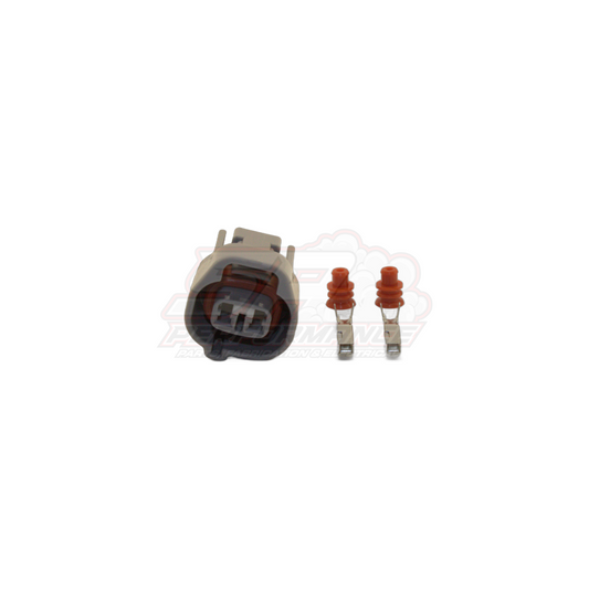 Two-pin Denso left guide connector kit with grey housing and two female terminals with red seals on white background