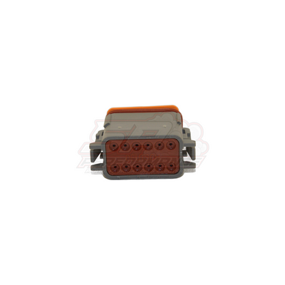 Front view of Deutsch DT06-12SA grey 12-pin male housing with orange locking wedge and brown terminal cavity insert showing dual row pin layout