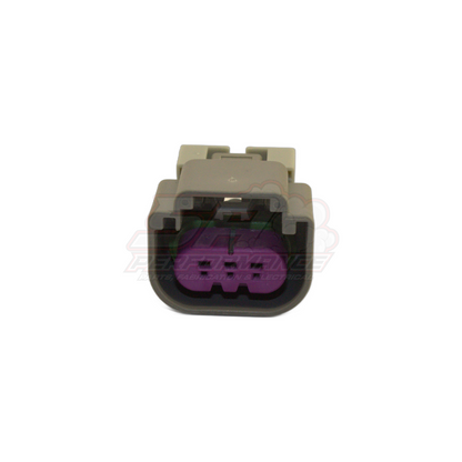 Front view of grey 3-pin E85 flex fuel sensor connector housing showing purple terminal insert with six contact positions and black locking latch