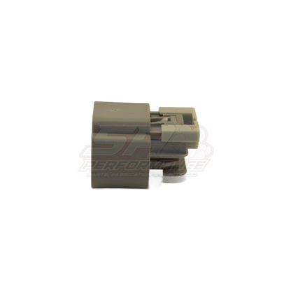 Grey plastic 3-pin automotive connector housing with black latch shown from side angle displaying mating face and locking tab for E85 flex fuel sensor harness