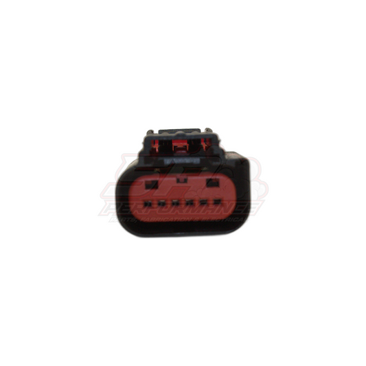 Front angle view of 6 pin throttle body connector showing black housing with red seal and terminal contacts for Ford Falcon and GM applications