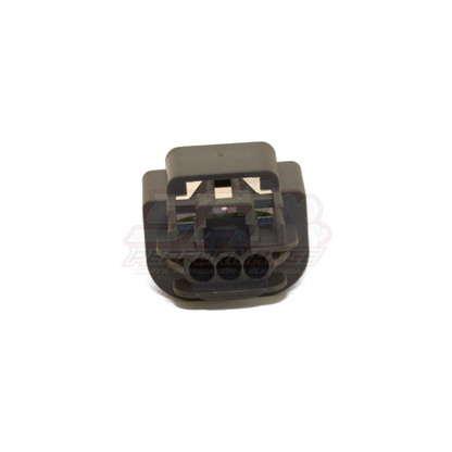 Grey GM 3-pin flex sensor connector housing angled view showing open terminal cavities and wire entry slots