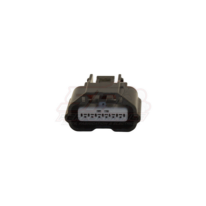 Front view of 6-pin Nissan Hitachi AFM sensor connector housing showing grey insert with terminal slots and locking clip
