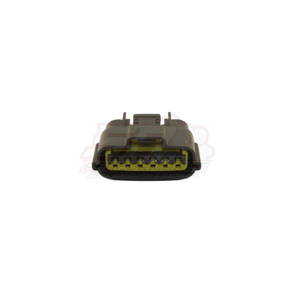 Front angled view of grey Nissan 6-pin igniter connector showing yellow terminal inserts and locking tabs on housing