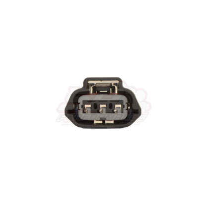 Front end view of black 3-pin Nissan ignition coil and TPS connector showing grey insert with three gold metal terminals and locking tab
