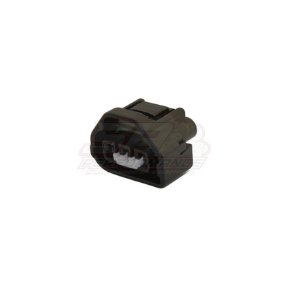 Angled view of black 3-pin TPS connector housing for Toyota Mazda throttle position sensor with white terminal insert visible