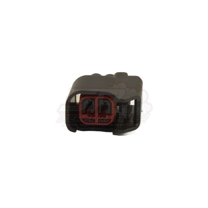 Front angled view of black 2-pin US car connector housing with red seal visible inside terminal cavities